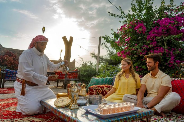 Pouring beverages for visitors at an Aseeri home